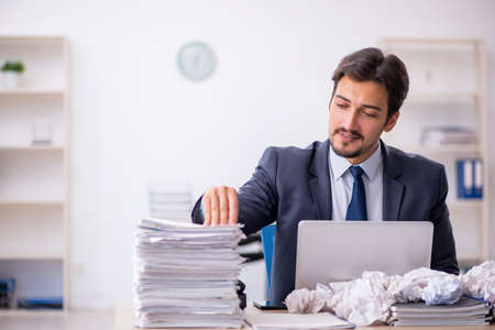 Young male employee in brainstorming conceptの写真素材