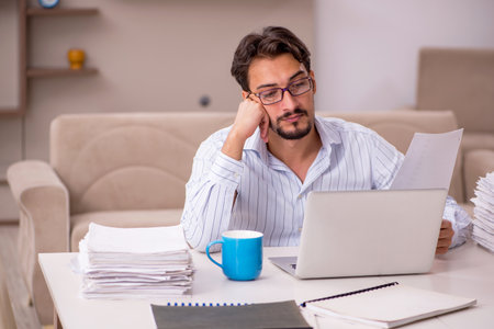 Young businessman employee working from home during pandemicの写真素材