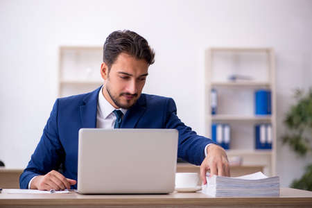 Young male employee working in the officeの写真素材