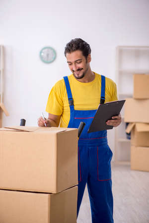 Young male contractor doing home relocationの写真素材