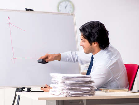 The young handsome financial speciaist in front of white boardの写真素材