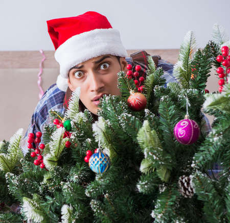 Man suffering hangover after christmas partyの写真素材