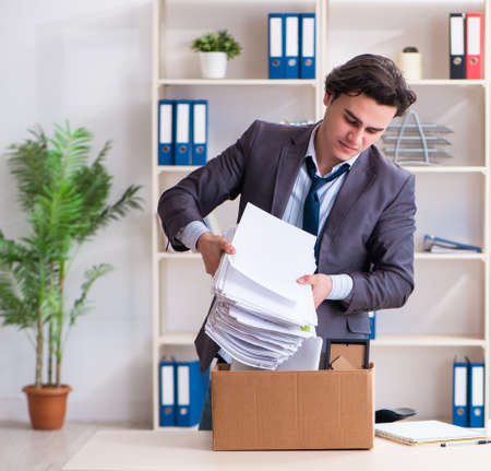 Young male employee being fired from his workの写真素材