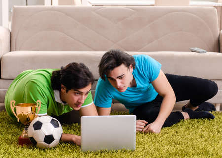 Friends watching football at homeの写真素材