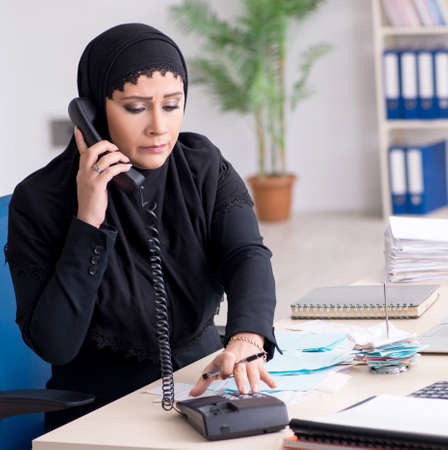 Female employee bookkeeper in hijab working in the officeの写真素材