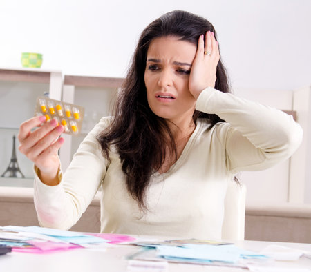 Young woman with receipts in budget planning conceptの写真素材