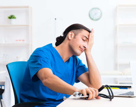Young male doctor working in the clinicの写真素材