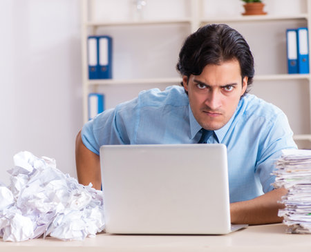 Businessman rejecting new ideas with lots of papersの写真素材
