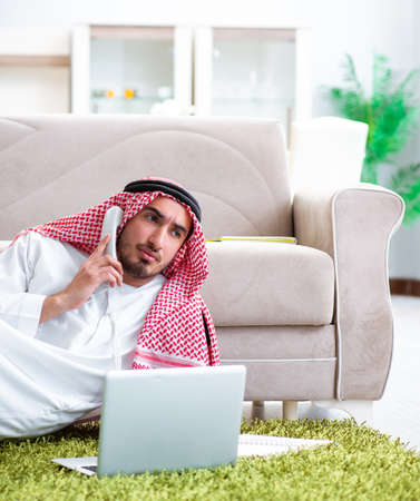 Arab man working at home on his workの写真素材