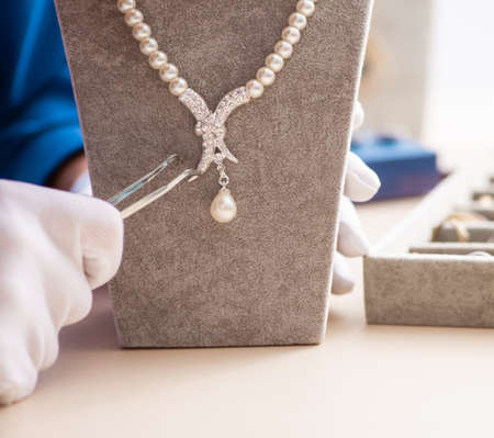 Young jeweler working in his workshopの写真素材
