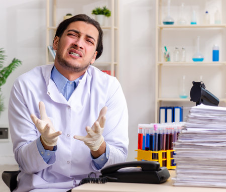 Young male chemist working in the labの写真素材