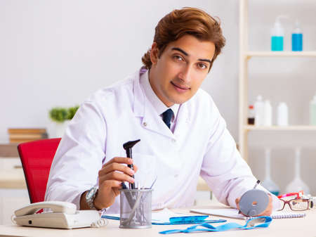 Young male doctor otolaryngologist working at the hospitalの写真素材