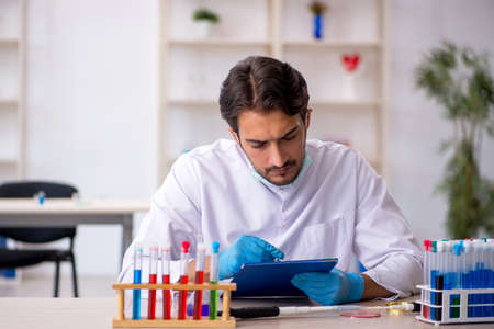 Young male chemist working at the labの写真素材