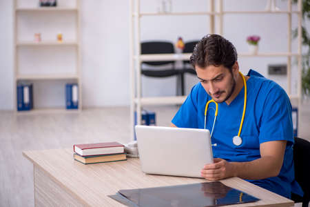 Young male doctor in telemedicine conceptの写真素材