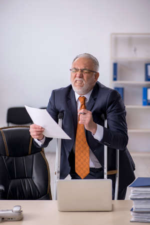 Old male employee after accident at workplaceの写真素材