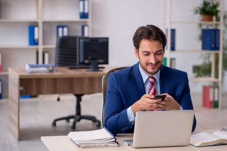 Young male employee working in the officeの写真素材