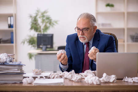 Old male employee in brainstorming conceptの写真素材