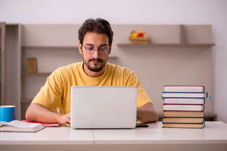 Young male student preparing for exams at homeの写真素材