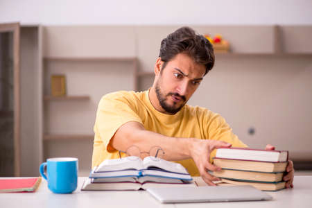 Young male student preparing for exams at homeの写真素材