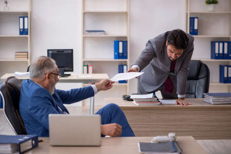 Two male colleagues working in the officeの写真素材
