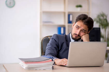 Young male employee working in the officeの写真素材