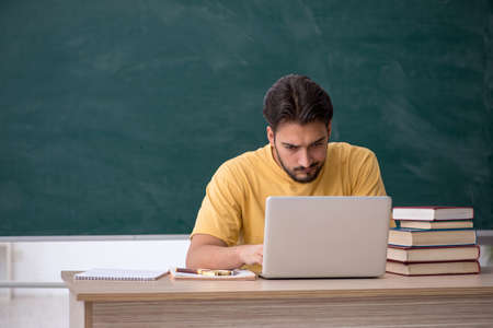 Young male student in telestudying conceptの写真素材