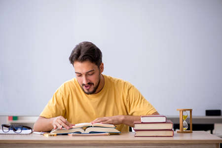 Young male student preparing for exams in the classroomの写真素材