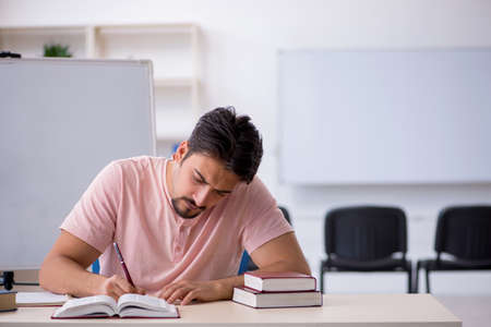 Young male student preparing for exams in the classroomの写真素材