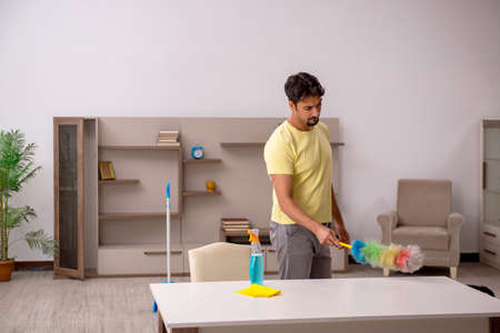 Young man doing housework at homeの写真素材