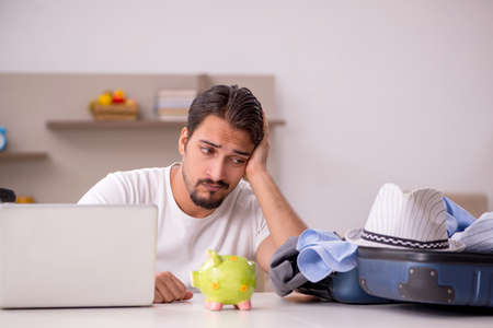 Young man preparing for trip at homeの写真素材