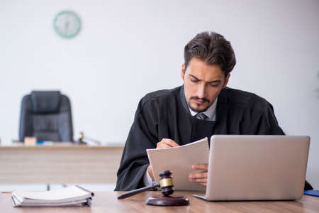 Young male judge working in the courthouseの写真素材
