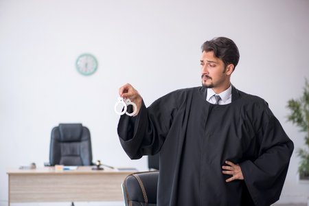 Young male judge working in the courthouseの写真素材