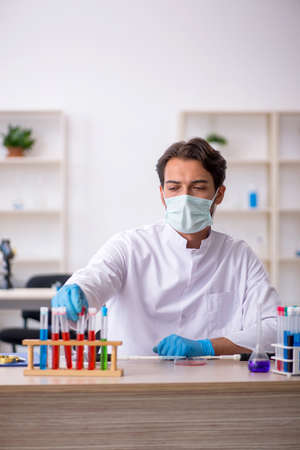 Young male chemist working at the labの写真素材