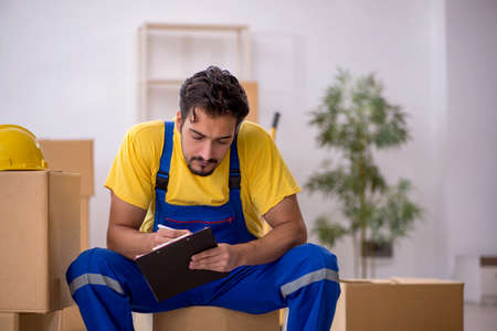 Young male contractor doing home relocationの写真素材