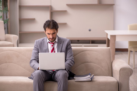 Young male employee working from home during pandemicの写真素材