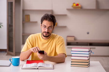 Young male student preparing for exams at homeの写真素材