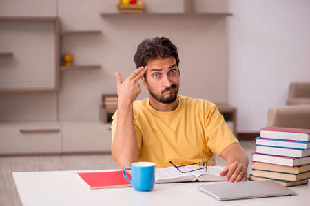 Young male student preparing for exams at homeの写真素材