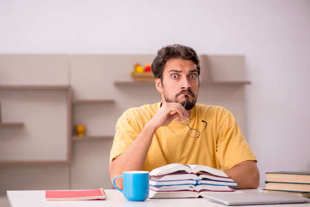 Young male student preparing for exams at homeの写真素材