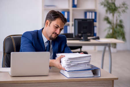 Young male employee working in the officeの写真素材
