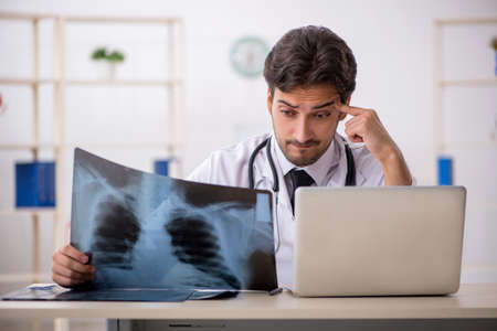 Young male doctor radiologist working in the clinicの写真素材
