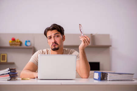 Young male employee working from houseの写真素材