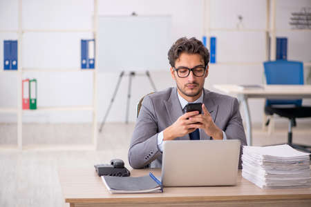 Young male employee sitting at workplaceの写真素材