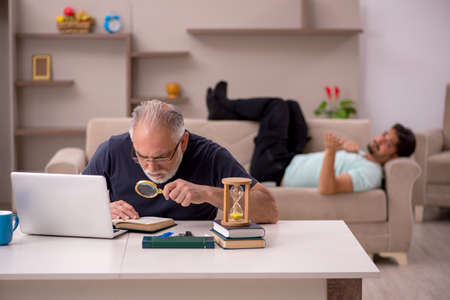 Old grandfather in distant learning concept during pandemicの写真素材