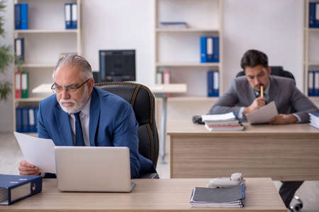 Two male colleagues working in the officeの写真素材