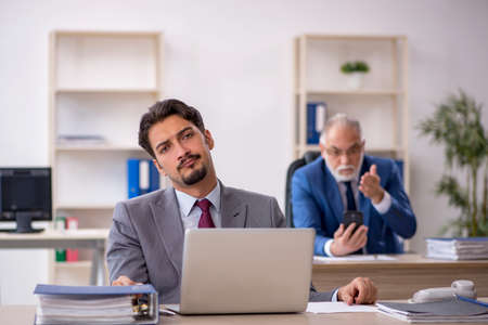 Two male colleagues working in the officeの写真素材