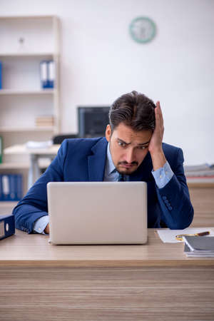Young male employee working in the officeの写真素材