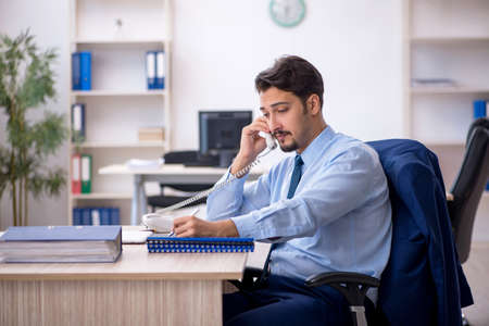 Young male employee working in the officeの写真素材