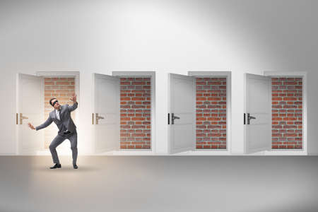 Businessman facing no exit with brick doorの写真素材