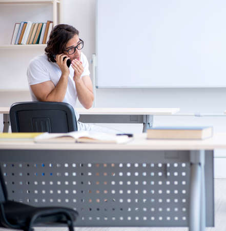 Young male student in front of whiteboardの写真素材