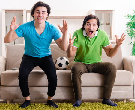 Friends watching football at homeの写真素材